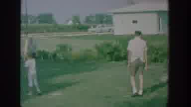 New York USA (1964): Many People Are In A Ground And Playing Beside A Road