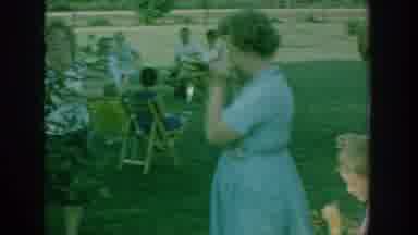 New York USA (1964): People Gathered Outdoors Peeling Husks Back Eating Their Corn