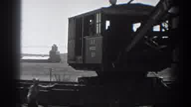 California USA (1936): Train Mounted Industrial Earth Moving Crane Operating In A