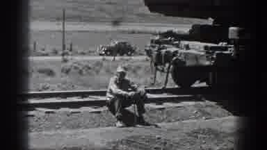 California USA (1936): Work Train Cart Swinging, Man Sitting On Railroad Tracks