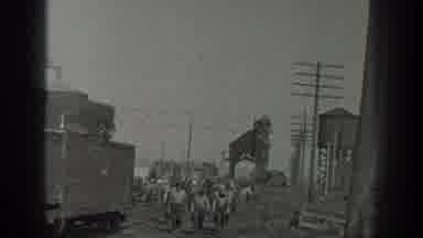 California USA (1936): Railroad Workers Walking Through Stockyard Then Doing Heavy