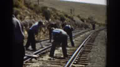 California USA (1936): Men Working On A Railroad Outside Near A Mountain Area