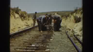California USA (1936): Several Men Conducting On Railroad Tracks For Consumers