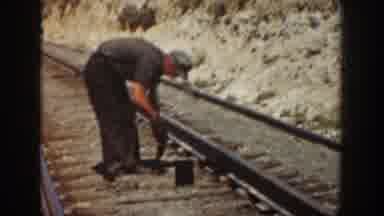 California USA (1936): Group Of Factory Workers Working On Railroad Sleepers In
