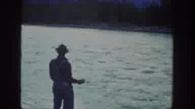 California USA (1936): Man With Fishing Gear Fishes On Swift Moving River Shore