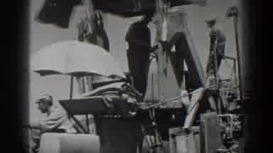California USA (1936): Moving Vintage Combine Harvester With Team Handling Grain