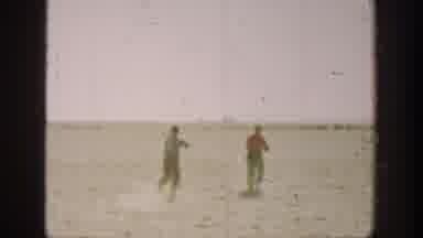California USA (1936): Two Boys Run Onto A Field As A Bird Falls Onto The Ground