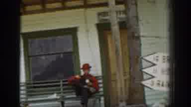 Chelan Washington USA (1939): Man And Boy Wearing Red Shirts Sitting Under Post
