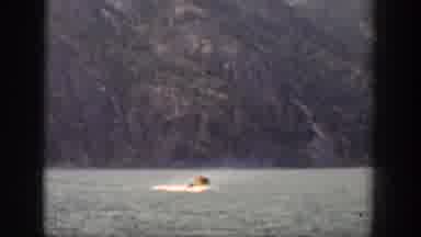 Chelan Washington USA (1939): Boat Moves Alone Through A Lake, Surrounded By