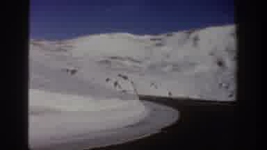 Aspen Colorado USA (1961): Snow Street Road Mountains Driving Trees Sky Car Winter