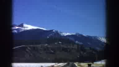 Aspen Colorado USA (1961): Driving Towards The Mountains In An Open Country Road