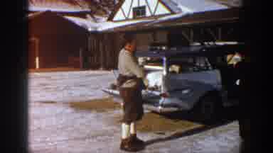 Aspen Colorado USA (1961): Man Prepares For Skiing In Front Of A Old Station Wagon