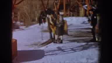 Aspen Colorado USA (1961): Man Wearing Black Yellow Sweater Rides Yellow Ski Lift