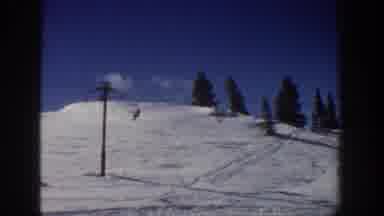 Aspen Colorado USA (1961): People Riding A Ski Lift Up A Ski Slope And Hanging Out