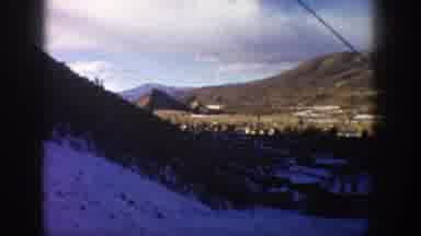 Aspen Colorado USA (1961): People On A Ski Lift Going Down In The Forest