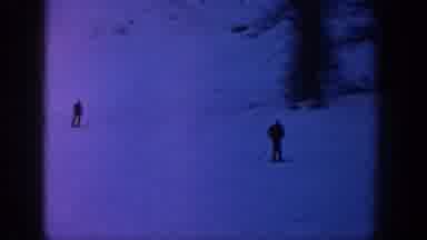Aspen Colorado USA (1961): Two Skiers Gracefully Skiing Down A Smooth Snowy