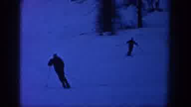 Aspen Colorado USA (1961): Two Skiers Ski In The Night And A Very Quick Image Of A