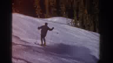 Aspen Colorado USA (1961): Man Skiing Down A Snow Mountain Next To Woods