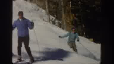 Aspen Colorado USA (1961): Two People Skiing Down Snow Covered Hill Sunny Day In
