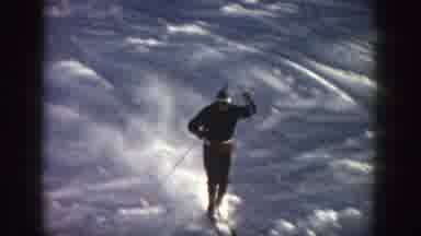 Aspen Colorado USA (1961): A Male Skier Skis Down The Slope Of A Small Ravine And