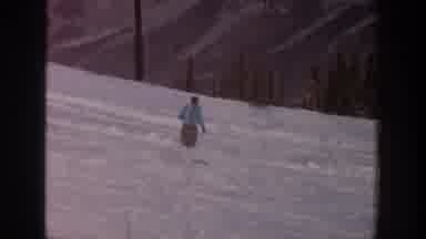 Aspen Colorado USA (1961): Men Ski Slowly Down A Gentle Mountain Decline Over