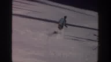 Aspen Colorado USA (1961): Two People Skiing Downhill On A Bright Sunny Winter Day