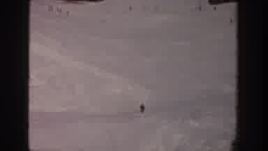 Aspen Colorado USA (1961): External Short Of Man Skiing Down A Slope Toward Other