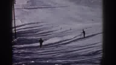 Aspen Colorado USA (1961): Two Mens Are Sliding In The Snow And Only One Is