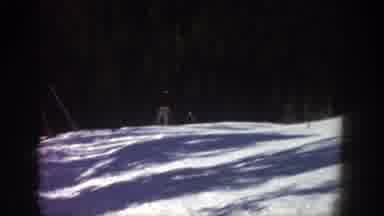 Aspen Colorado USA-1961: Lone Skier on Snowy Slope with Forest Backdrop