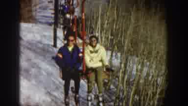 Aspen Colorado USA (1961): Group Of People Sitting On A Ski Lifting And Waving