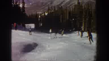 Aspen Colorado USA (1961): People Skiing Down A Mountain And Going Around A Turn