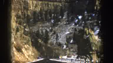 Aspen Colorado USA (1961): A Vehicle Travels Down A Highway In The Mountains