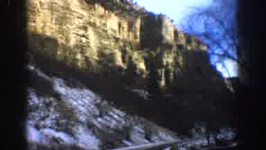 Aspen Colorado USA (1961): Car Driving Down Snowy Paved Road Surrounded By