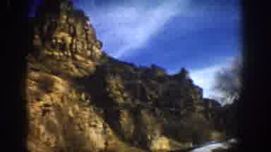 Aspen Colorado USA (1961): Driving Through A Canyon With A Wet Road And Snow On