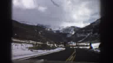 Aspen Colorado USA (1961): Driving Down Road With Yellow Line With Mountains And
