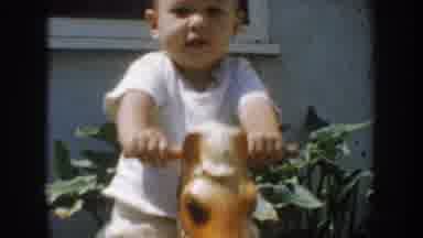 California USA (1952): Little Baby On A Docking Horse And Then Mom Fixing Baby's
