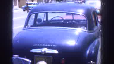California USA (1952): People Standing Near Dark Blue Car Parked Near People
