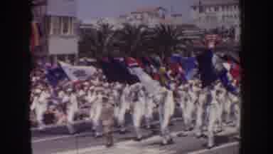 California USA (1952): Sailors Carrying Bright Colored Flags In Parade On Bright