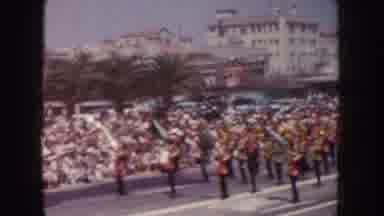 California USA (1952): A Parade Marching Down A Wide Avenue With Buildings And