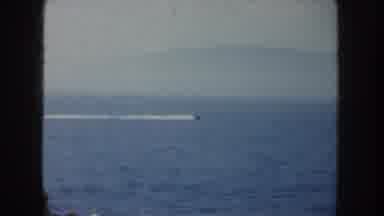 California USA (1952): A Boat Racing Across A Large Expanse Of Water While A Crowd