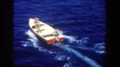 California USA (1952): Two Men Wearing Colorful Shorts Sitting On A Boat In A Sea