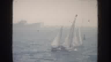 California USA (1952): Sailing Ship With Two Masts In Front Of A Large Ship With A