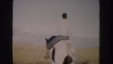 South Dakota USA (1953): Man Riding A Beautiful Dark Brown And White Horse In A