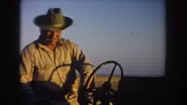 South Dakota USA (1953): A Man In A Cowboy Hat Spins The Steering Wheel Of A