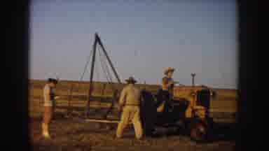 South Dakota USA (1953): Farmers Getting On A Tractor And Driving Away