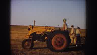 South Dakota USA (1953): Men Unhitching Empty Trailer From Tractor On A Sunny Day