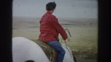 South Dakota USA (1953): Woman In Red Jacket Horseback Riding In Field