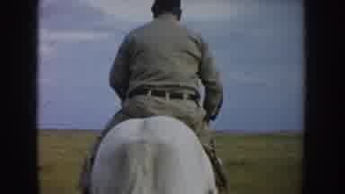 South Dakota USA (1953): Older Man Wearing Uniform Style Clothing Riding On A