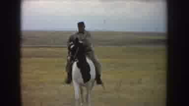 South Dakota USA (1953): A Fat Guy Riding A Horse On A Field In Front Of The