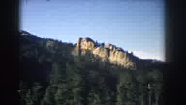 South Dakota USA (1953): Passing View Of Mountains And Trees Against Clear Blue